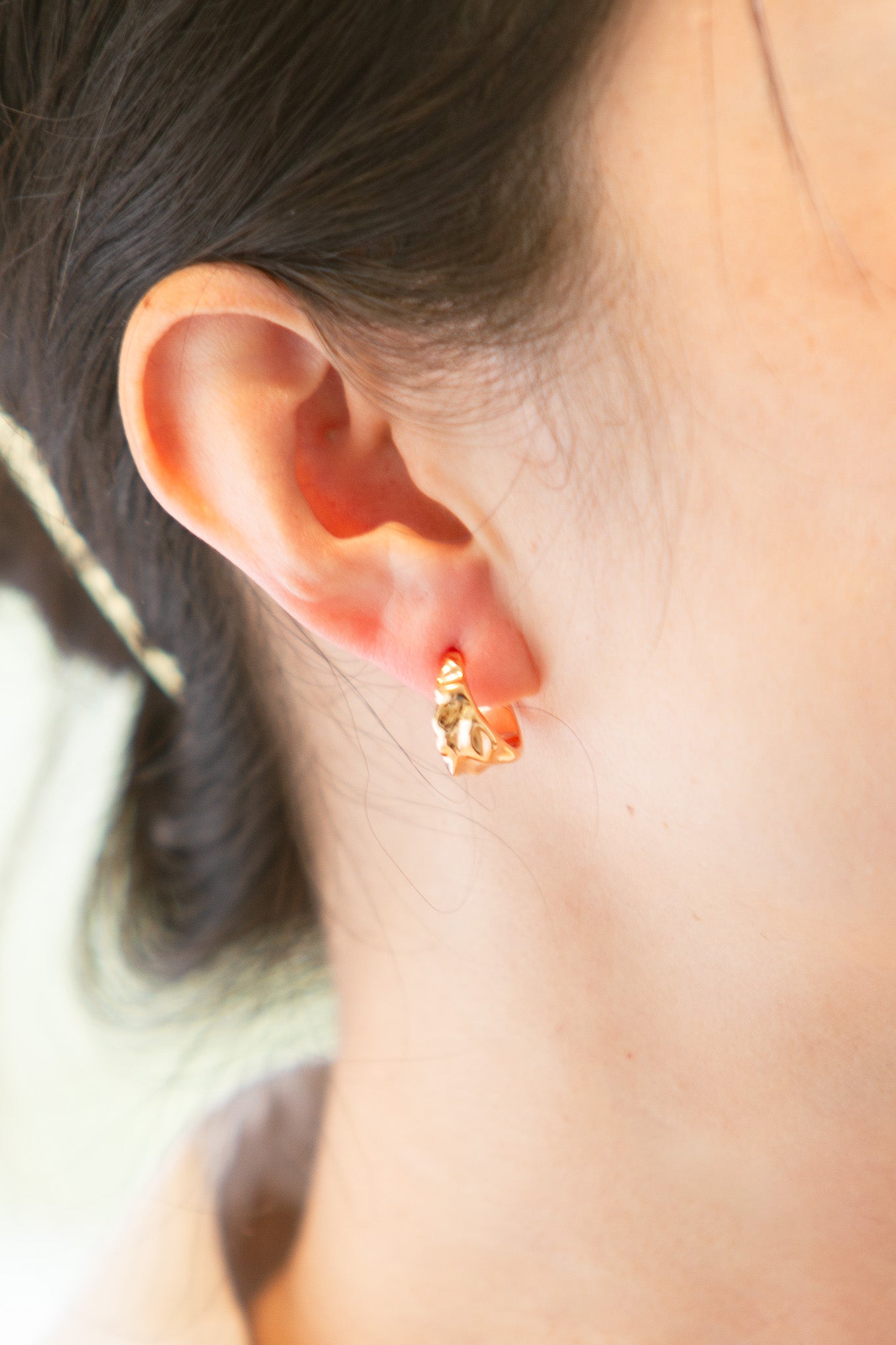 JAMT.B Gold Molten Hoop Earrings on person